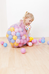 little girl playing with balls