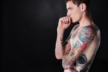 handsome young man covered with tattoo.