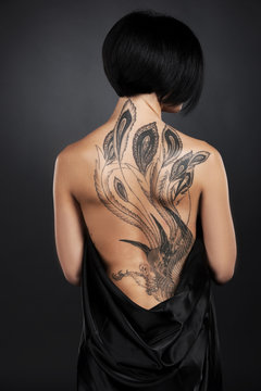 beautiful young lady with back tattoo.
