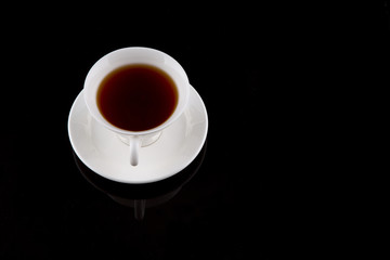A cup of tea over black background