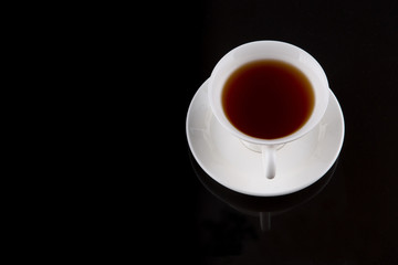 A cup of tea over black background