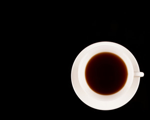 A cup of tea over black background