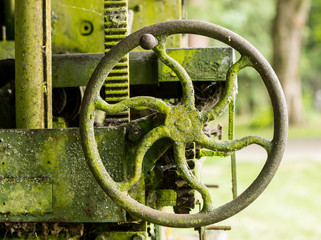 Moss covered farm machinery with handle