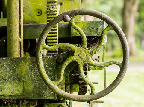 Moss covered farm machinery with handle