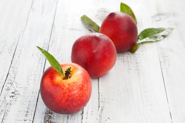 Fresh and ripe peaches on a table
