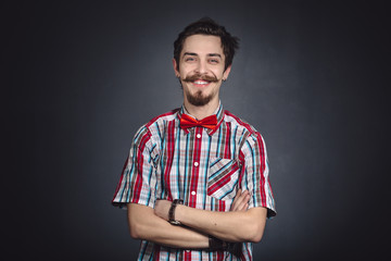 Man in plaid shirt and bow tie in the studio