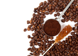 Coffee grains, spoon of grind grains and crystal sugar