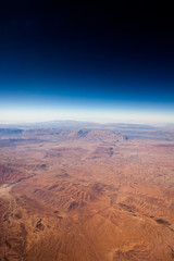 Fototapeta na wymiar View at the brown mountains from airplane