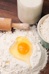 Yolk and egg white in a hill of flour