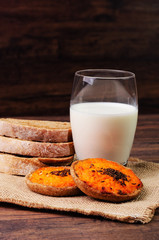 Two carrot pies with a glass of milk and bread