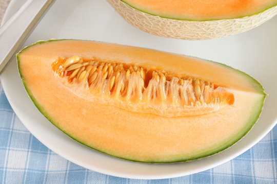 Cantaloupe melon sliced in half showing the seeds and flesh
