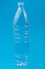 Transparent plastic bottle on a blue background