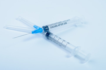 Closeup photo of medical syringes on a gray background