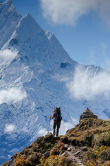 Naklejka na ściany i meble Hiker walks on train in Himalayas