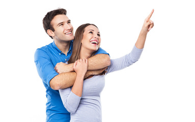 Young couple pointing up