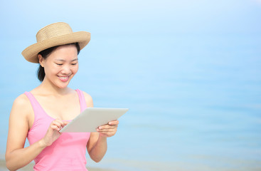 summer holiday woman use digital tablet on seaside beach