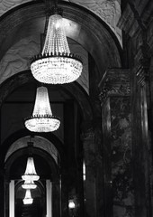 chandeliers reflecting in a mirror in black and white