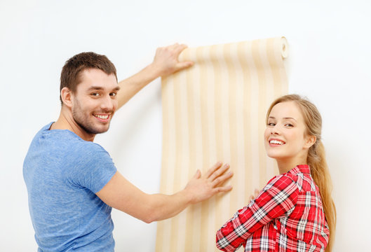 Smiling Couple Choosing Wallpaper For New Home