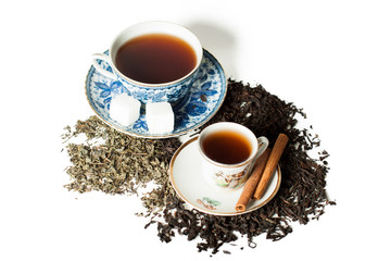 two cups with saucers, sugar and cinnamon