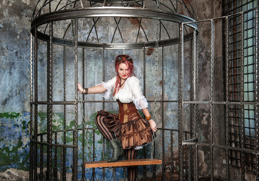 Beautiful sexy steampunk woman in the cage