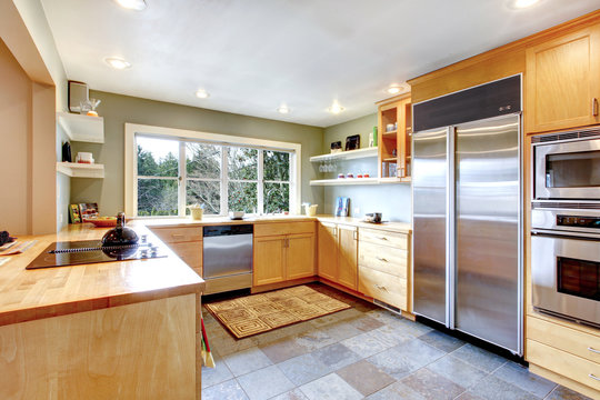 Kitchen with maple cabinets and steel appliances