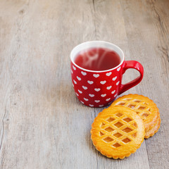 Tea cup and cookies on wooden table