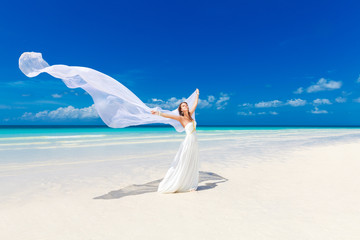 Fototapeta na wymiar beautiful fiancee in white wedding dress and big long white trai