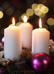 Three candles with christmas decoration