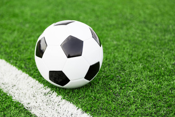 Fototapeta na wymiar Traditional soccer ball on soccer field