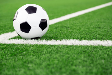 Obraz na płótnie Canvas Traditional soccer ball on soccer field