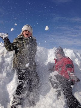 two boys have snowball fight