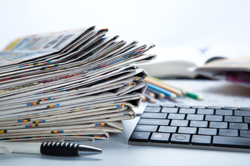 stack of newspapers and keyboard close-up
