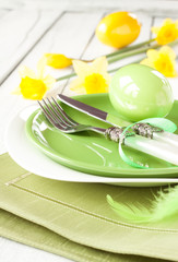 Easter or spring table setting with fresh daffodil flowers