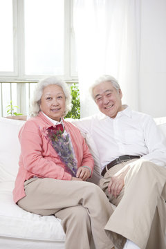 .Senior couple holding a bunch of roses.