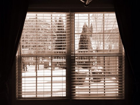 View from window outside to the deck with snow