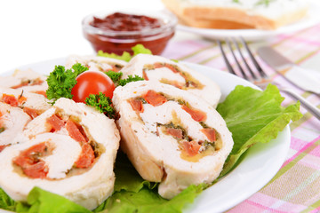 Delicious chicken roll on plate on table close-up