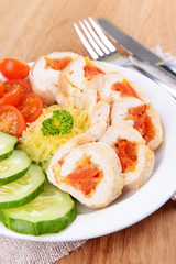 Delicious chicken roll on plate on table close-up