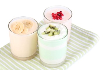 Delicious yogurt with fruits tastes in glasses