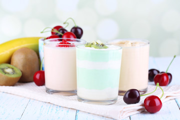 Delicious yogurt with fruits tastes in glasses and fresh fruits