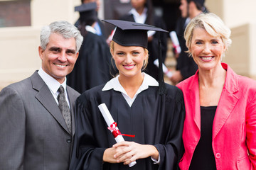 young female graduate with parents