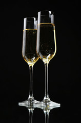 Glasses of champagne, on black background