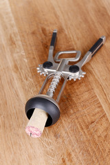 Corkscrew on wooden background