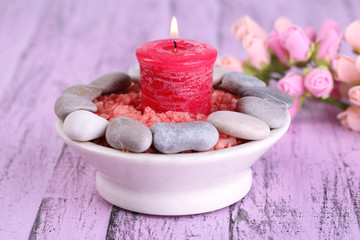 Composition with spa stones, candle  and flowers