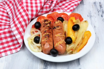 Grilled sausages on wooden table