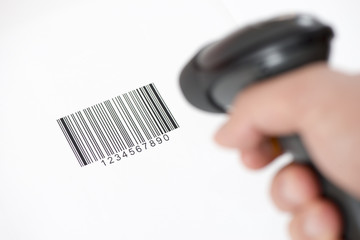 The manual scanner of bar codes in man hand - obrazy, fototapety, plakaty