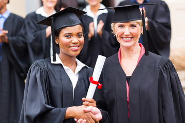 african female graduate handshaking with dean