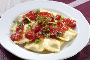 Portion of ravioli with tomato sauce