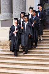 young graduates walking down the stairs
