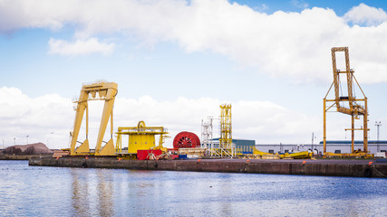 Horizontal color image of heavy machinery in docks.