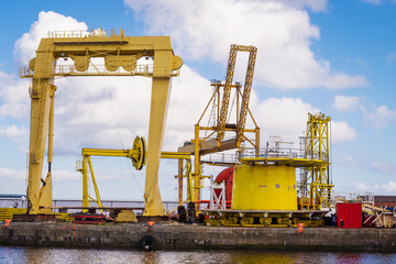 Horizontal color image of heavy machinery in docks.